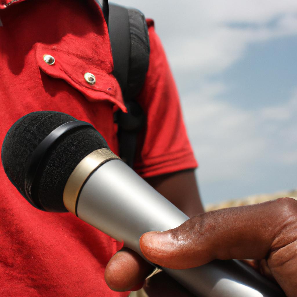 Person holding microphone, interviewing someone